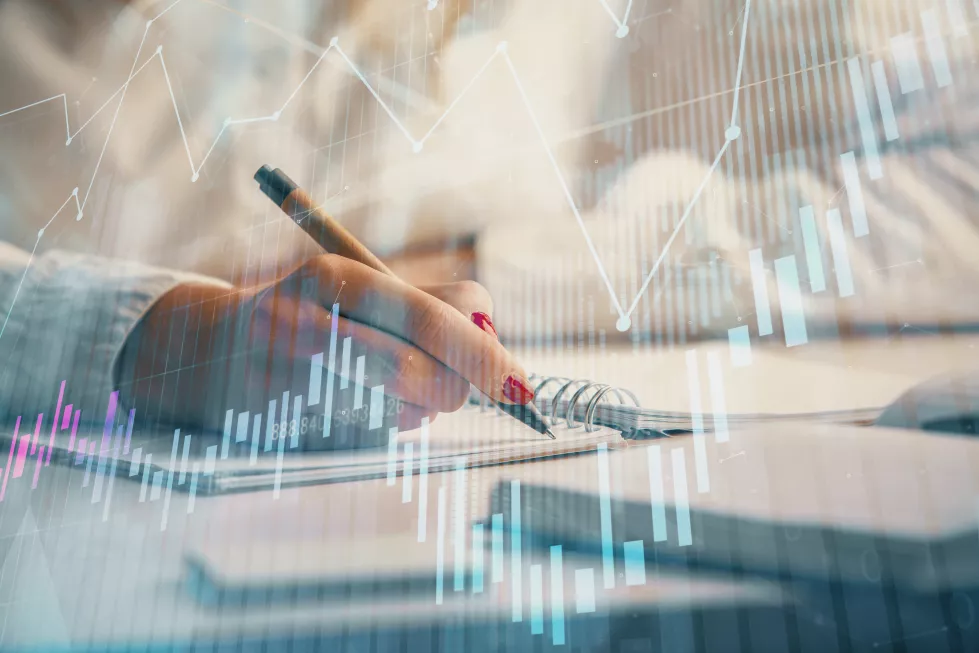 double-exposure-womans-hands-making-notes-with-forex-graph-hologram-concept-stock-market-analysis