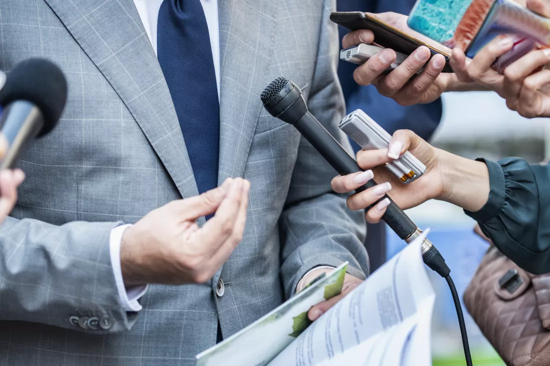 cropped-hands-journalists-interviewing-businessman-city