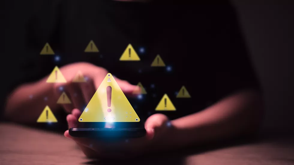 programmer-developer-using-computer-tablet-with-triangle-caution-warning-sign-notification-error-maintenance-concept