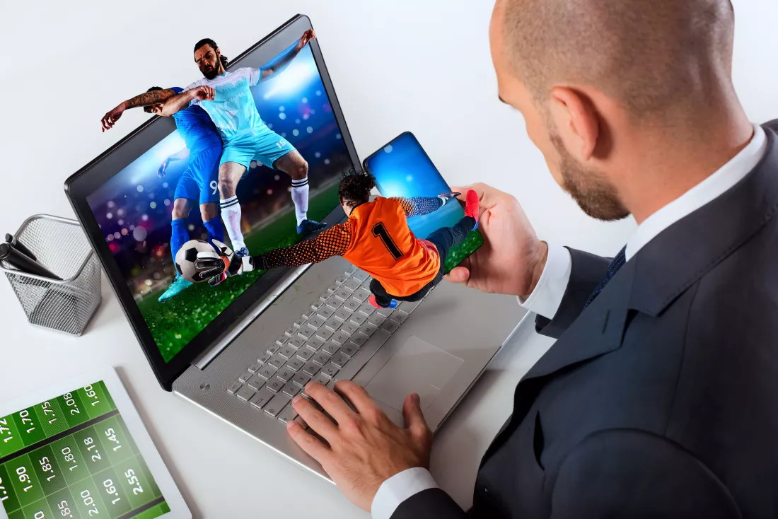 businessman-watches-football-match-bets-soccer-website
