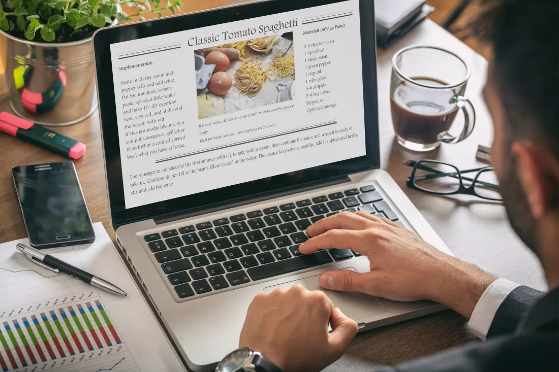 man-working-laptop-recipe-screen