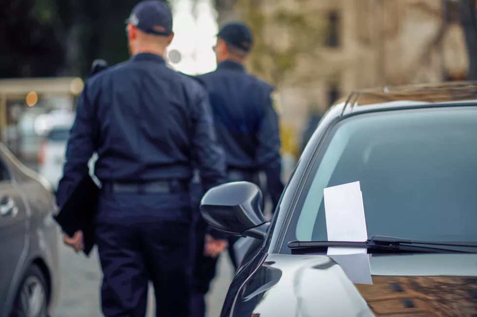 two-male-police-officers-checking-car-parking